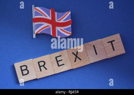 Kreatives Konzept: die britische Politik: 3d-Union Jack Flagge und das Wort Brexit isoliert auf einem blauen Hintergrund Stockfoto