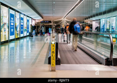 Dublin, Irland - Januar 2019 Flughafen Dublin, Menschen hetzen für Ihre Flüge, langen Korridor mit Fahrsteig, Bewegungsunschärfe Stockfoto