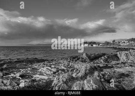 Die Stadt von Largs auf den Firth of Clyde an der Westküste von Schottland. Über flechten bedeckte Felsen in die Stadt. Eine gute touristische Schwarz & whi Stockfoto