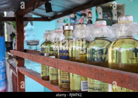 BALI, Indonesien - November 20, 2013: Illegale benzin Benzin ist an der Seite der Straße in recyceltem Glas Wodka Flaschen in Bali, Indonesien verkauft. Stockfoto