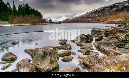 Ein Blick auf die schneebedeckten Snowdon Horseshoe von Llyn (See) Mymbyr in Capel Curig, Wales, Großbritannien Stockfoto