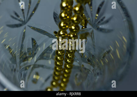 Makro Kunst Abstrakte schöne defokussierten Kristallglas mit goldfarbenen Mardi Gras Perlen Stockfoto