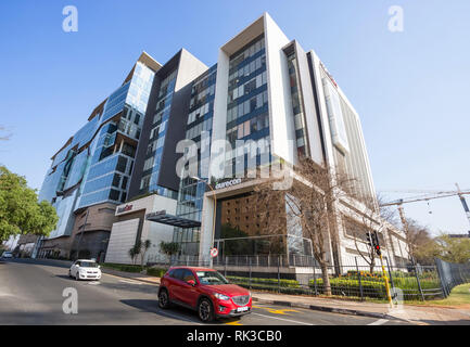 Johannesburg, Südafrika, 24. August - 2018: Modernes Bürogebäude mit Autos im Vordergrund. Stockfoto