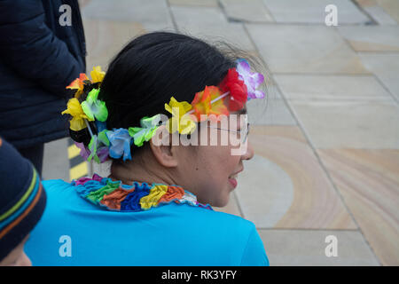 Woking, Surrey, Großbritannien. 9. Februar, 2019. Woking Zentrum feierte das Chinesische Neue Jahr des Schweins heute mit bunten Paraden und Shows. Einer der Tänzer im Kostüm warten. Stockfoto