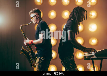 Zwei Musikern auf der Bühne. Nach oben Schließen Seitenansicht Foto. festival Konzept Stockfoto