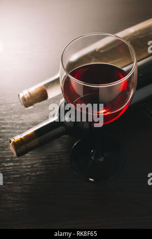 Wein glasse und Flaschen auf einer hölzernen Hintergrund Stockfoto