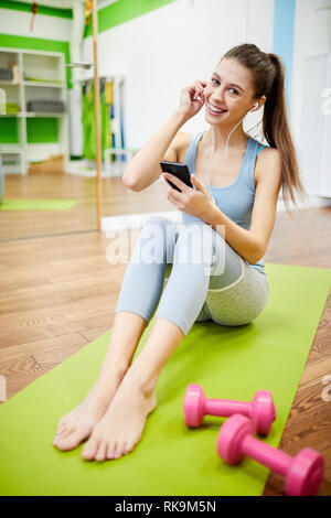 Lächelnde Frau, die Pause vom Training Stockfoto