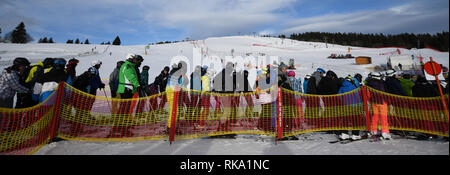 Feldberg im Schwarzwald, Deutschland. 10 Feb, 2019. Skifahrer Linie bis zu einem Aufzug. Quelle: Patrick Seeger/dpa/Alamy leben Nachrichten Stockfoto