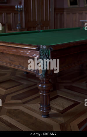 Im Vordergrund Ecke der Billardtisch. Billard ist alt und massiv. Billard aus Holz. keine Kugeln auf dem Billardtisch. Die Tabelle steht in einer Ro Stockfoto