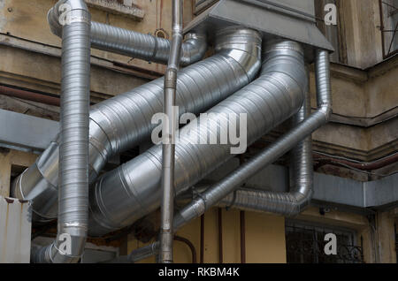 Verflechtung von Silber Luftkanäle in verschiedenen Durchmessern auf dem alten Gebäude closeup Stockfoto