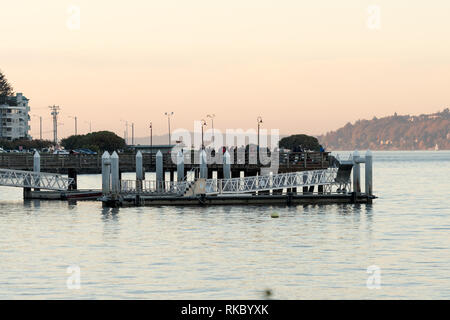 Menschen Fischen bei Sonnenuntergang an den Docks von North Admiral, Seattle, Washington, USA. Stockfoto