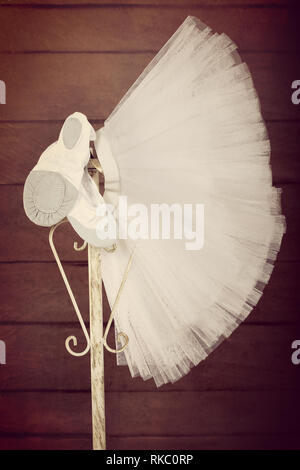 Pointes weiblichen Ballett Schuhe mit Rock tutu hängen auf dem stand, in der Nähe vintage anzeigen Stockfoto