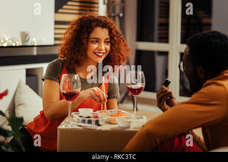 Rothaarige curly Frau an ihren Mann beim Abendessen auf der Suche Stockfoto