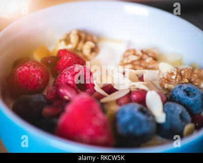 Leckeres und gesundes Frühstück Schüssel mit Himbeere, Heidelbeere, Mandel-, Granatapfel, Walnüsse und Soja Joghurt Stockfoto