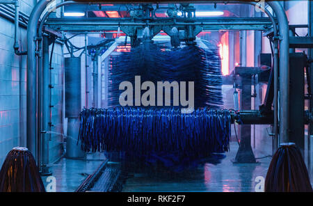 Auto waschen, Detailansicht Auto waschen, car wash Schaum Wasser, automatische Autowäsche in Aktion, moderne Pinsel Autowaschanlage blaue Farbe abgestuftes Konzept Stockfoto