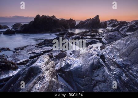 Sunset Cove Arymer Devon, Großbritannien Stockfoto