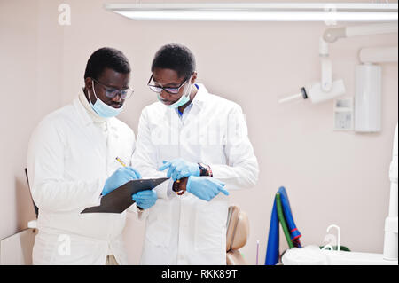 Zwei afrikanische amerikanische männlichen Kollegen Ärzte arbeiten zusammen, diskutieren und in Zwischenablage auf Klinik. Stockfoto