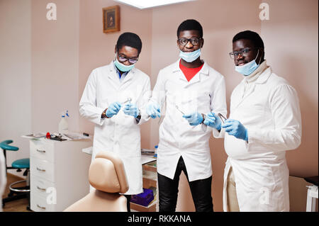 Drei afrikanische amerikanische männliche Ärzte Kollegen mit Werkzeugen an Händen in der Klinik. Stockfoto