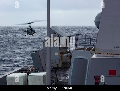 Mittelmeer, Jan. 29, 2019 - Ein AH-1W Super Cobra Kampfhubschrauber mit der 22 Marine Expeditionary Unit, landet auf dem Flugdeck der San Antonio-Klasse amphibious Transport dock Schiff USS Arlington LPD (24), Jan. 29, 2019. Die USS Arlington einen geplanten Einsatz als Teil der 22 MEU und der kearsarge Amphibischen bereit, zur Unterstützung der Maritime Security Operations, Krisenbewältigung und Theater Zusammenarbeit im Bereich Sicherheit und zugleich eine vorwärts Naval und Marine Präsenz. (U.S. Marine Corps Foto: Staff Sgt. Andrew Ochoa/Freigegeben) Stockfoto