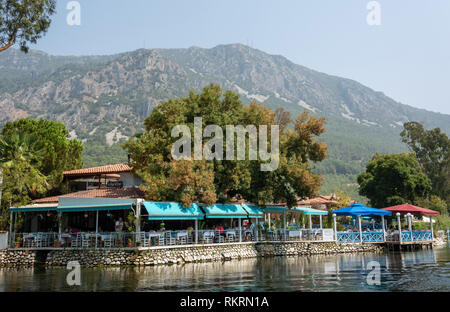 Akyaka, Mugla, Türkei - 30. Juli 2016. Restaurant entlang der Azmak stream in Akyaka Dorf in der Provinz Mugla in der Türkei, mit Menschen. Stockfoto