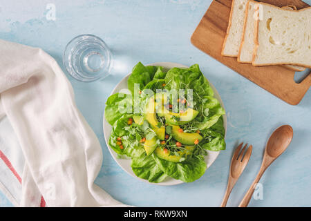 Gesunde avocado Toast zum Frühstück oder Mittagessen mit Brot in Scheiben Avocado, Rucola, Kürbis und Sesamsamen, Salz und Pfeffer. Vegetarische Sandwiches. P Stockfoto