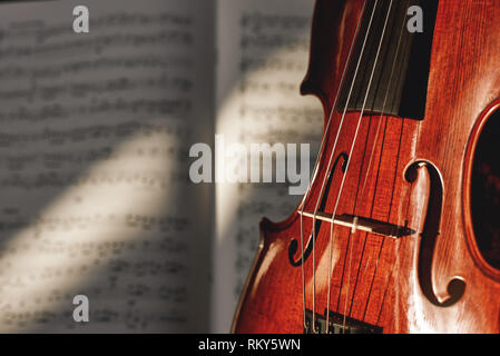 Vorbereitung auf ein Konzert. Classic Brown Violine auf Musik Notenblatt Hintergrund. Musikinstrumente. Musik Equipment. Geigenunterricht Stockfoto