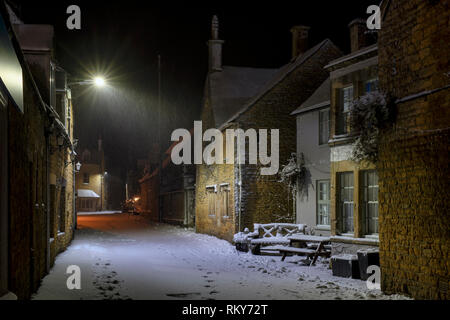 Sherborne Street in Bourton auf dem Wasser am frühen Morgen Schnee vor der Morgendämmerung. Bourton auf dem Wasser, Cotswolds, Gloucestershire, England Stockfoto