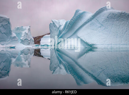 Eisberge in den ruhigen Gewässern von Rode Fjord wider. Stockfoto