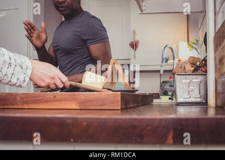 Ein homosexuelles Paar Geschichten von Ihren Tag bei der Arbeit über eine Scheibe Toast und eine Tasse Tee und Kaffee am Abend. Stockfoto