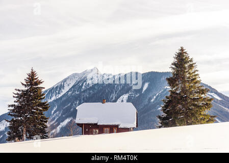 Mountain House und zwei Bäume, schneebedeckten Bergen im Hintergrund, im Skigebiet Schladming-Dachstein, Bezirk Liezen, Steiermark, Österreich, Europa Stockfoto