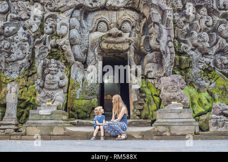 Mutter und Sohn sind Touristen in alten hinduistischen Tempel von Goa Gajah in der Nähe von Ubud auf Bali, Indonesien. Reisen in Bali mit Kindern Konzept Stockfoto