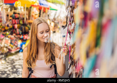 Frau Reisenden wählen Sie Souvenirs in den Markt in Ubud auf Bali, Indonesien Stockfoto