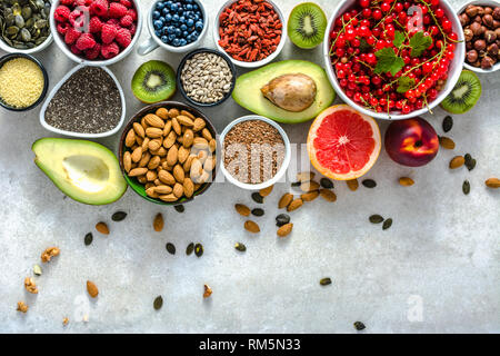 Gesundes Essen auf den Tisch. Frühstück in einem Schälchen mit frischen Produkten, organische Superfood, vegane Ernährung mit Früchten, Nüssen und Beeren, Stockfoto