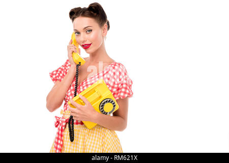 Schönen Pin up Girl mit Vintage gelb Telefon und Kamera Stockfoto