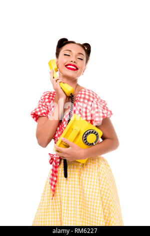 Lächelnd glücklich Pin up Girl mit Vintage gelb Telefon Stockfoto