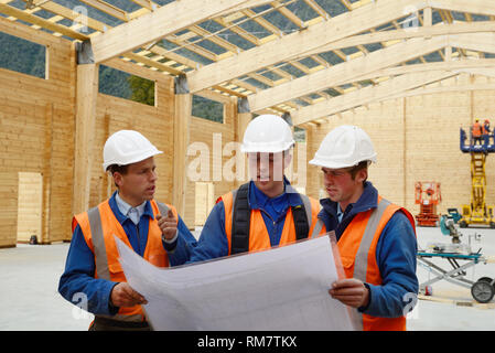 Drei Bauherren diskutieren den Plan für einen großen Bau job Stockfoto