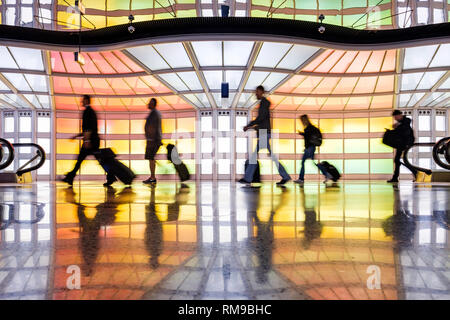 Fluggäste, Menschen zu Fuß, Neonlichter Kunstinstallation von Michael Hayden, Travellers Airport, Chicago O'Hare International Airport Terminal, USA Stockfoto