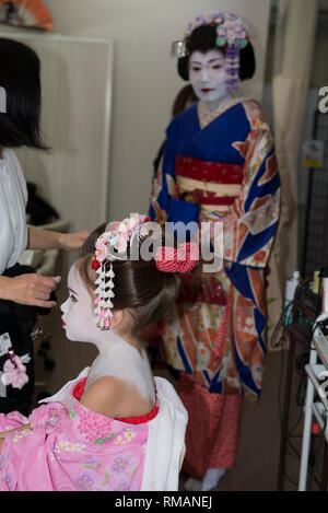 Geisha, Junges Mädchen, verkleidet und als Geisha gemacht, die von der Mutter beobachtet wird, die auch als Geisha, Kyoto, gekleidet ist Stockfoto