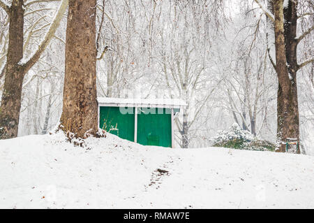 Eine grüne Farbe cabin Lodge in einem dichten Wald bei Schnee Saison. Ein Haus in einer Winterlandschaft Stockfoto