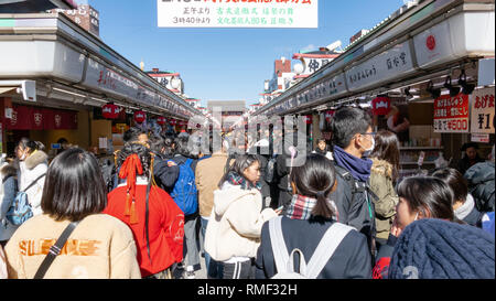 Tokio, Japan - Februar 1, 2019: Massen von Touristen und Einheimischen zu Fuß und Geschäften entlang der Einkaufsstraße Nakamise Dori durch Sensoji Heiligtum in Asakusa Viertel Stockfoto