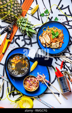 Verschiedene asiatische Abendessen essen eingestellt. Chicken Teriyaki mit Nudeln und Miso Suppe. Gerichte der thailändischen Küche. Ansicht von oben. Stockfoto