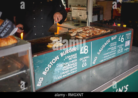 London, UK - Juni, 2018. Lincolnshire Würstchen und Eier auf einem Grill an der Straße Essen gekocht in Borough Market Stall. Stockfoto