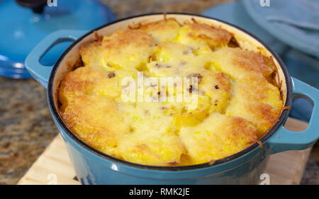 Gebackene Kartoffelgratin in blau Gusseisen backen Topf mit geschmolzenem Käse auf der Oberseite Stockfoto