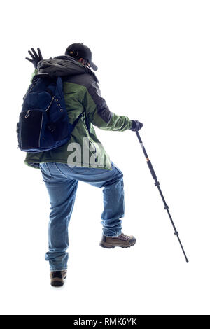 Bergsteiger oder Wanderer etwas mit einem Stock. Der Mann ist isoliert und wie er etwas in seinen Weg sucht, Stockfoto