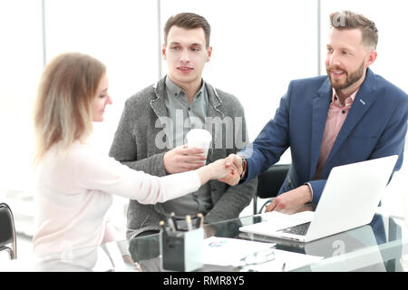 Kaufmann und Kauffrau schütteln sich die Hände an einem angenehmen Business Meeting. Stockfoto