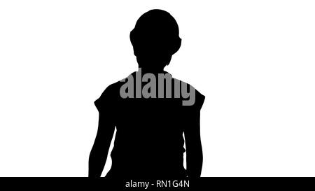 Silhouette Frau in Bau Outfit sprechen beim Gehen auf die Kamera. Stockfoto