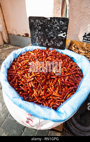 Getrocknete rote Chilischoten in der Tasche zum Verkauf am Markt, Nahaufnahme, Tageslicht Stockfoto