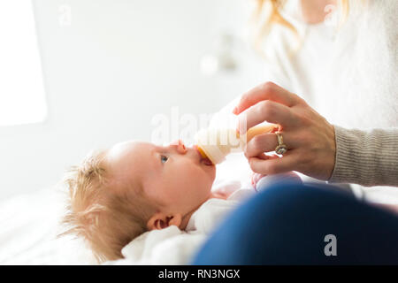 Hand der Frau, die ihr Baby Sohn Füttern aus der Flasche Stockfoto