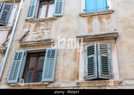 Alte Fenster mit blauen Fensterläden im alten Haus. Vintage Hintergrund, Textur Stockfoto