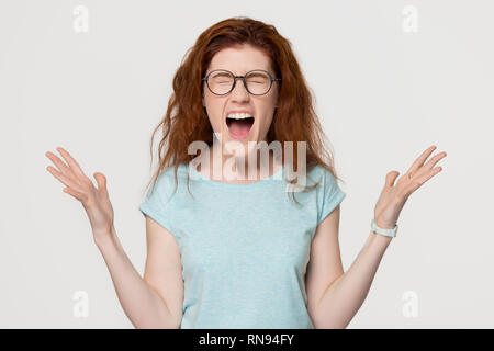 Wütend mad redhead hysterischen Mädchen kreischen Schreien auf Hintergrund isoliert Stockfoto